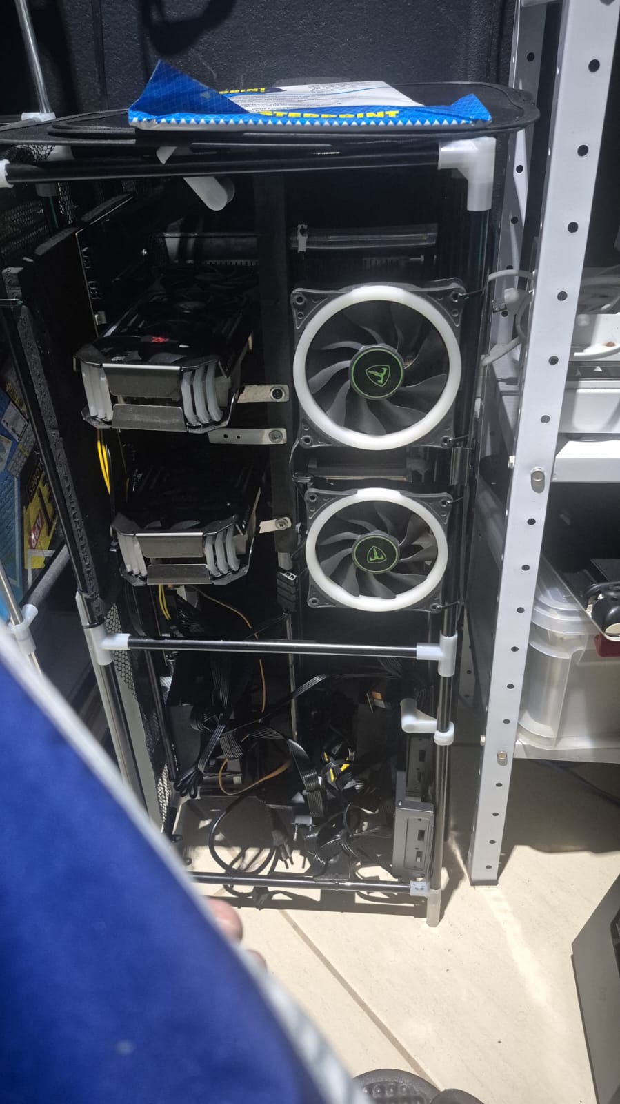Open frame with two graphics cards mounted vertically, power supply and cabling visible